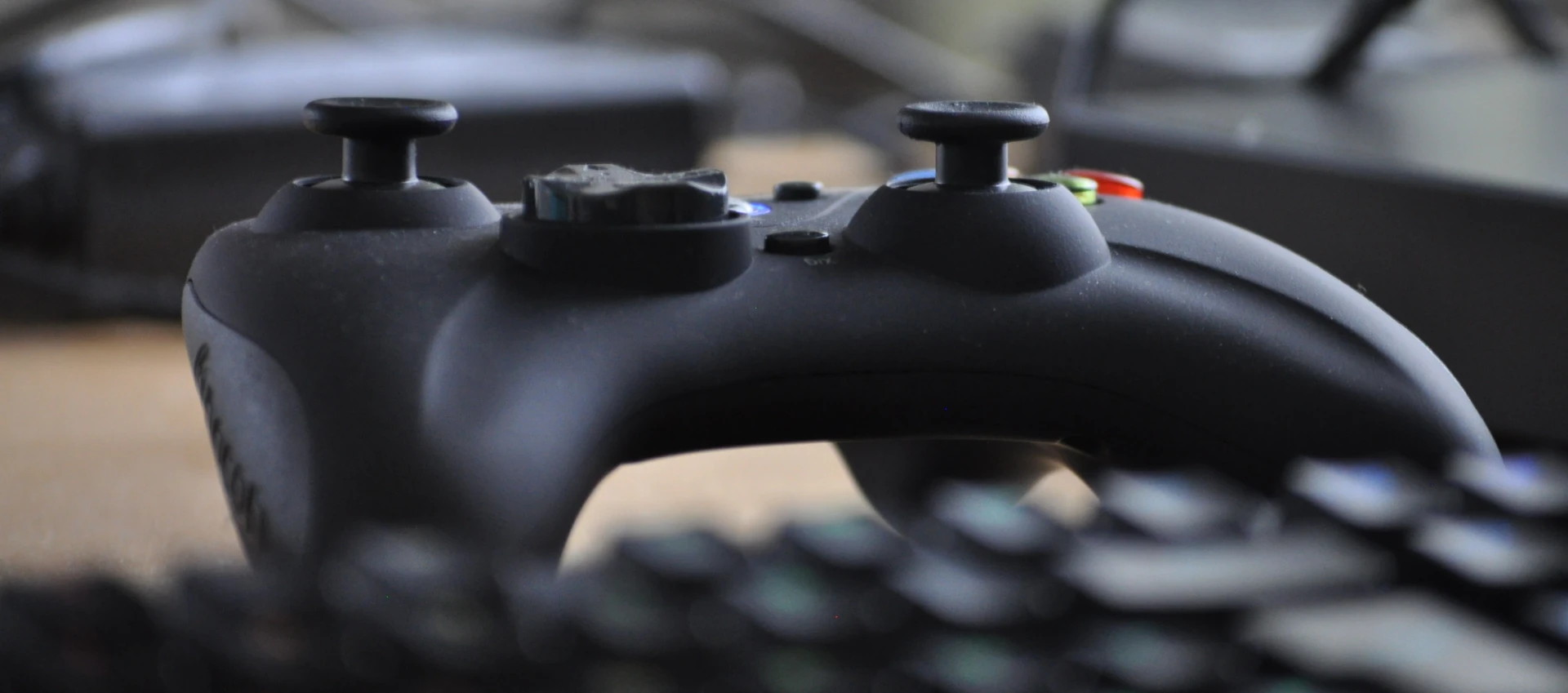 Picture of a third party Xbox controller behind a keyboard